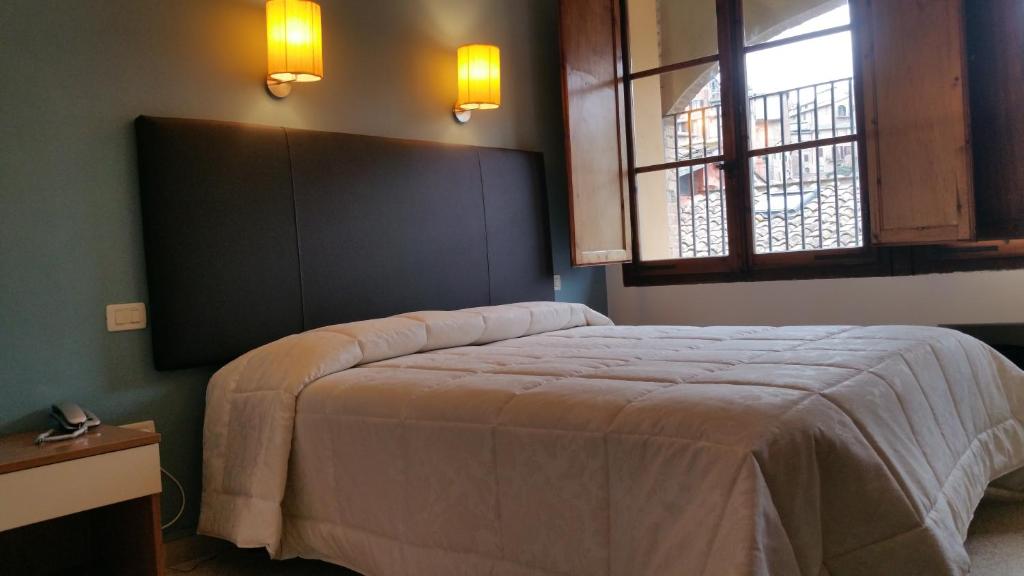 Postel nebo postele na pokoji v ubytování Hotel Alma Domus