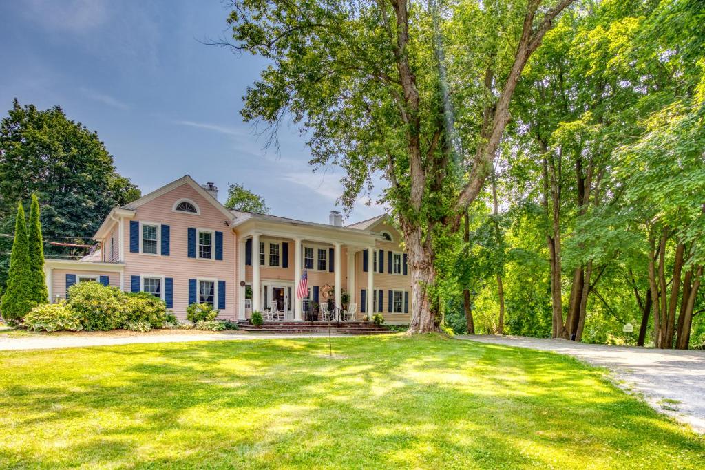 a large white house with a large yard at The Inn at Stockbridge in Stockbridge