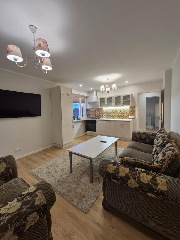 a living room with two couches and a table at Boose Apart in Kobela