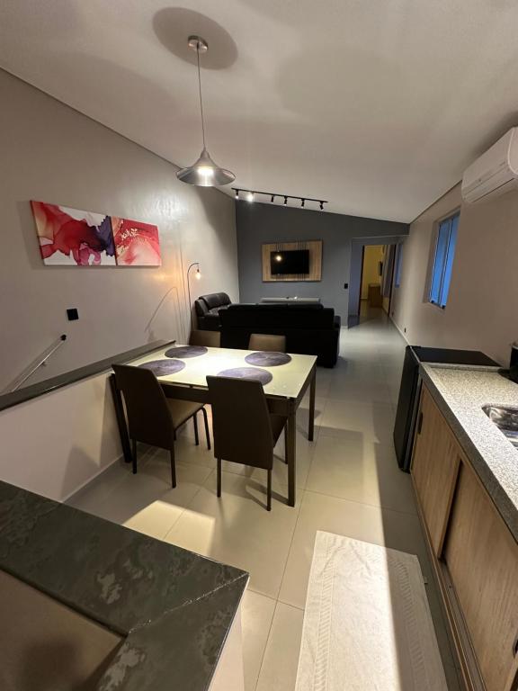 a living room with a table and a couch at Lito Palace Hotel in Registro