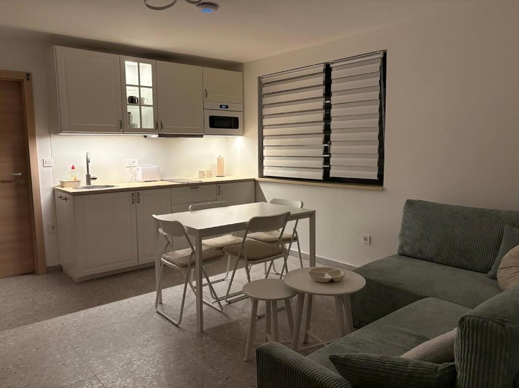 a living room with a couch and a table and a kitchen at Apartment 45 in Crikvenica