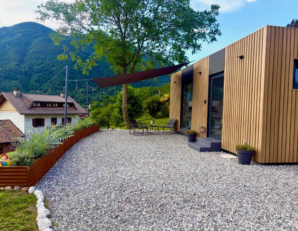 a house with a patio with a table and chairs at Everest Experience in Paluzza