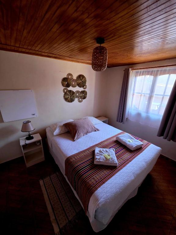 a bedroom with a bed with two boxes on it at Hostal Desert in San Pedro de Atacama