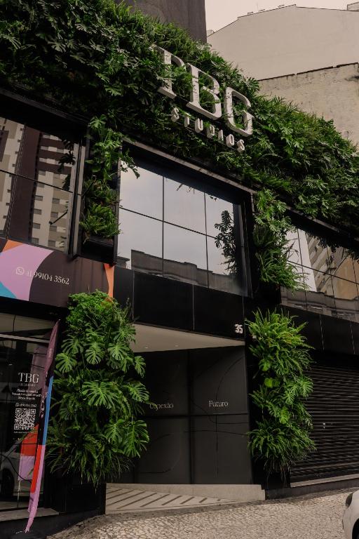 a building with plants on the front of it at TBG Studios in Curitiba