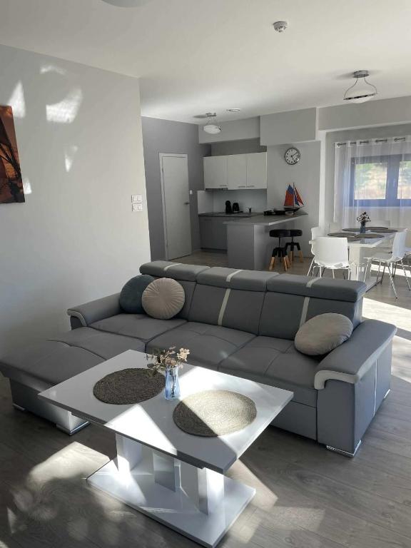 a living room with a couch and a table at WidziMisie Summer Apartament in Dominice