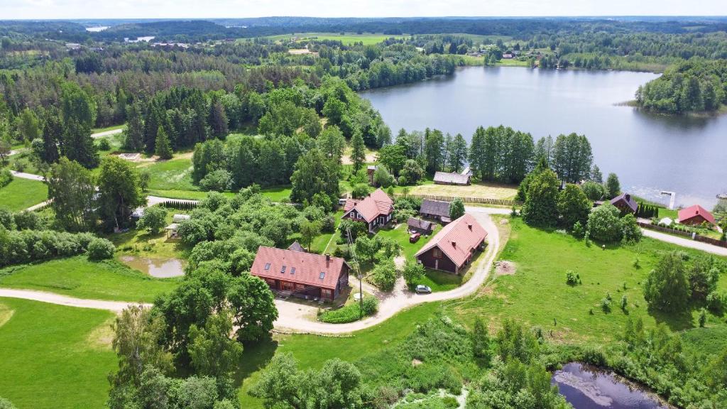 an aerial view of a house on the shore of a lake at Sunny Beaver B&B in Trakai