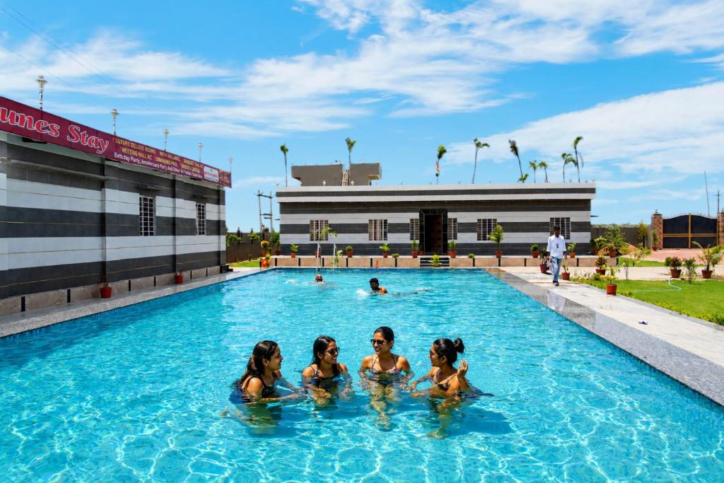 three women in the swimming pool at a hotel at Sand Dunes Stay in Bagru