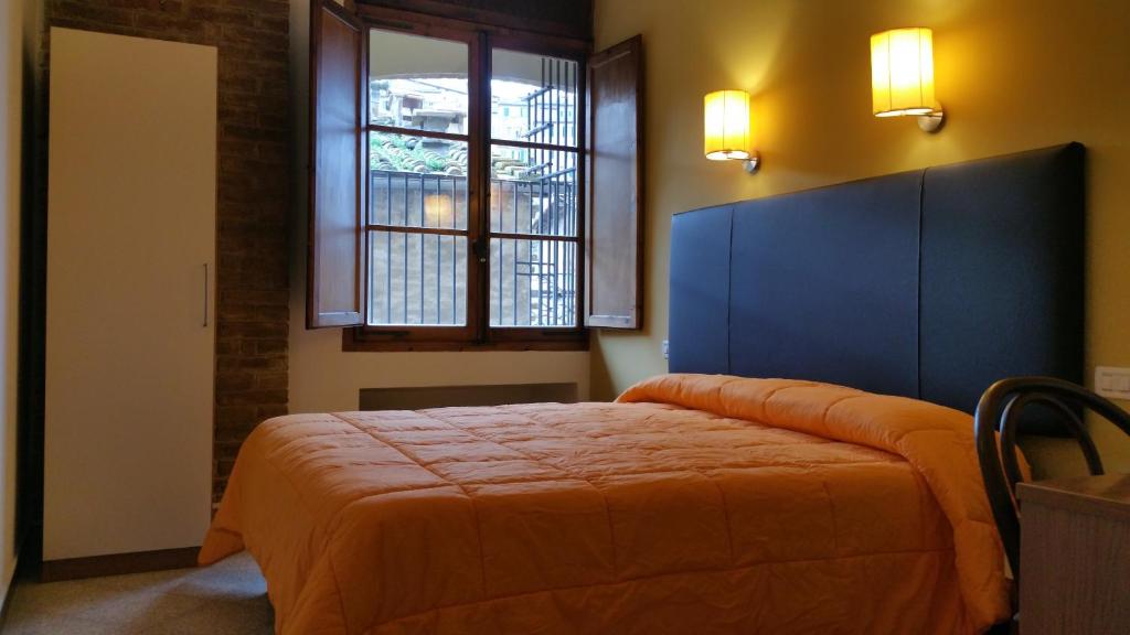 Postel nebo postele na pokoji v ubytování Hotel Alma Domus