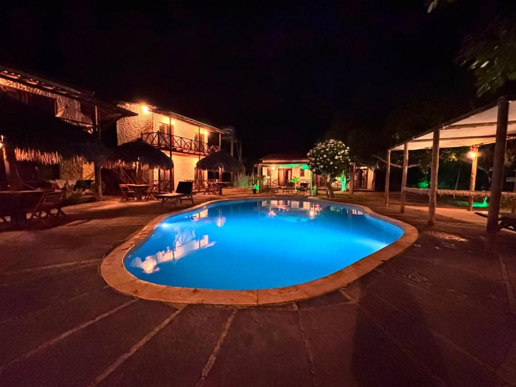 a swimming pool in the middle of a street at night at Pousada Juventus in Barra Grande