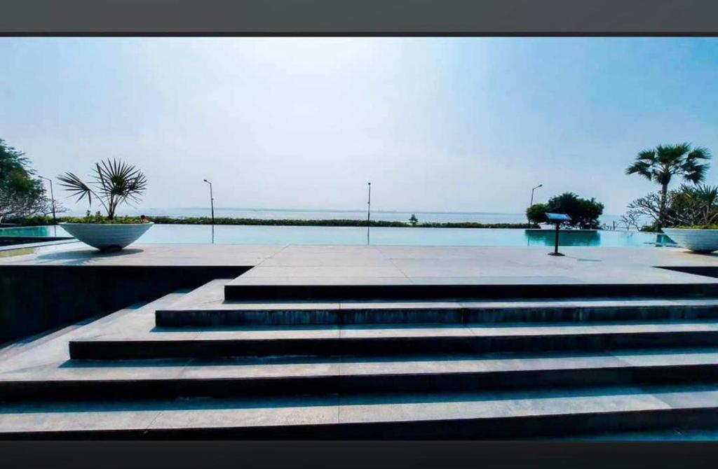 a group of steps leading to a swimming pool at Tranquil villa Raichak in Diamond Harbour