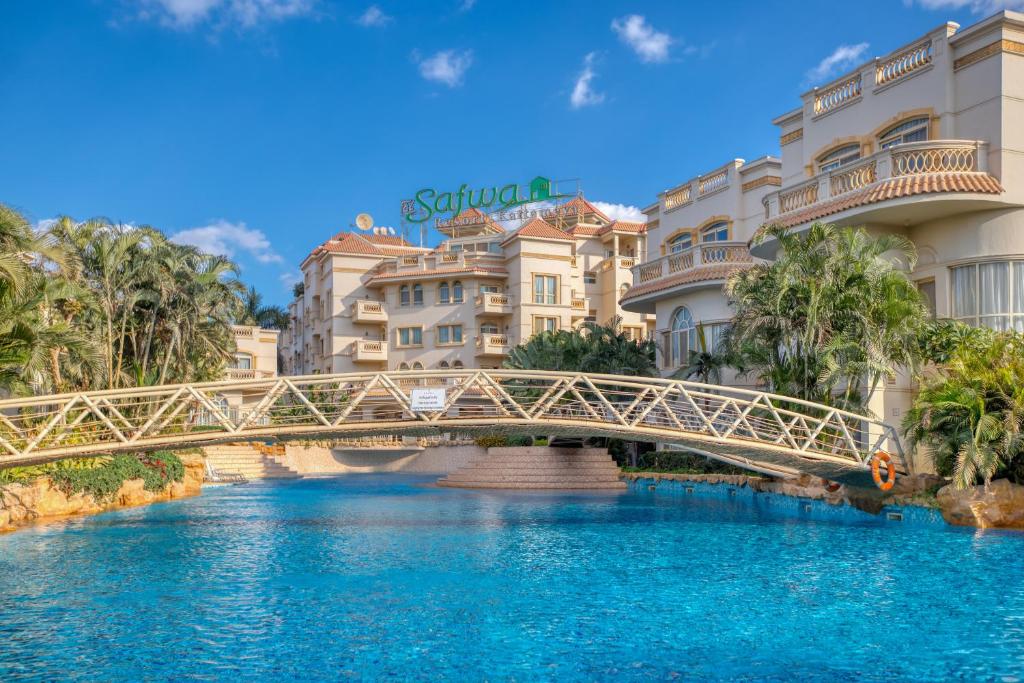 a bridge over a river in front of buildings at El Safwa Resort New Cairo in Cairo