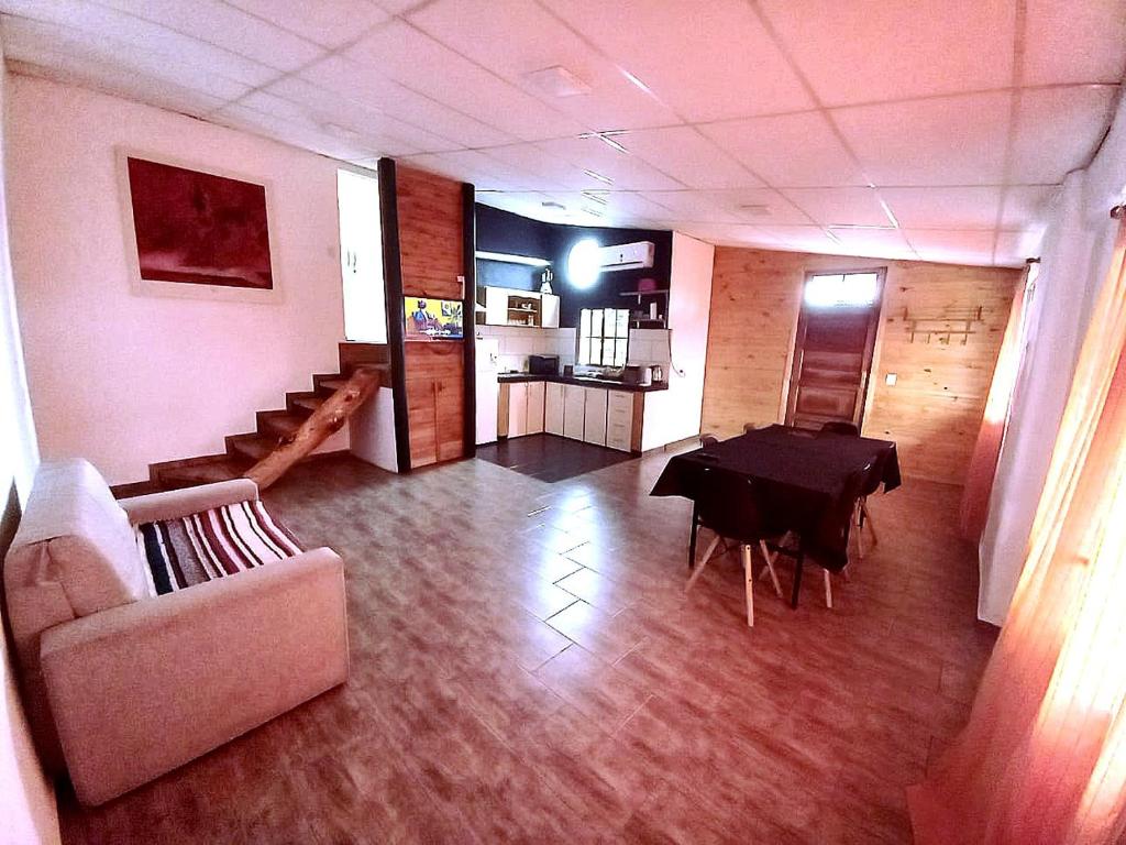 a living room with a table and a couch at Casa Petricor in Río Tercero