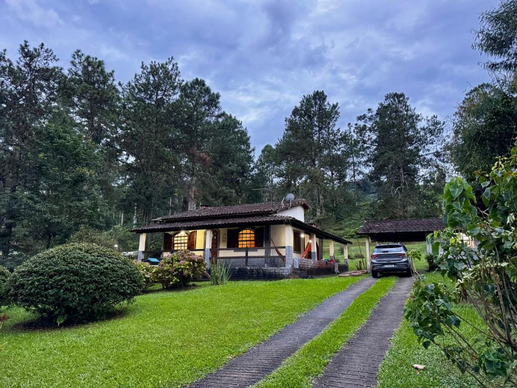 a house with a car parked in front of it at Casa da Neuza in Resende