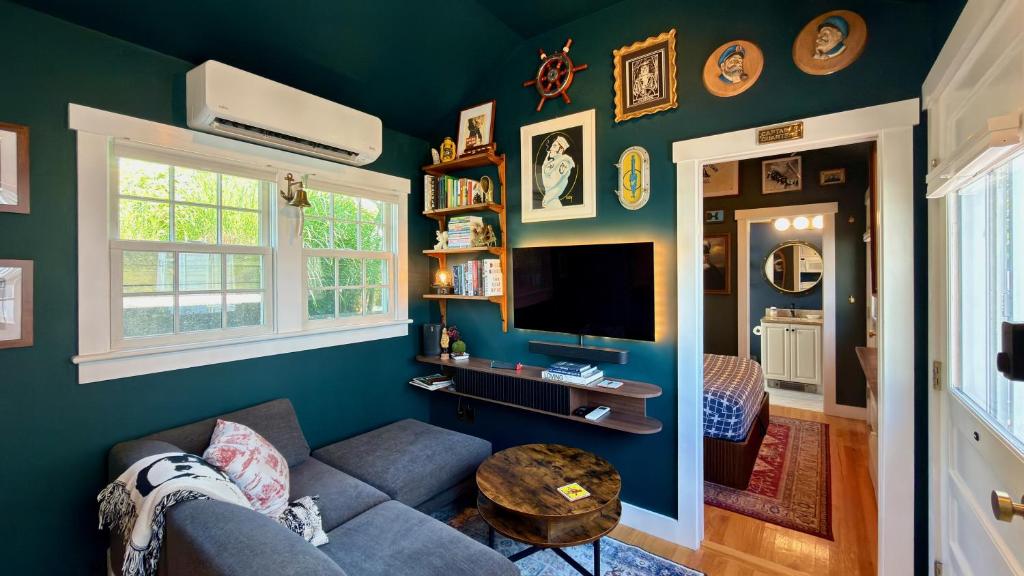 a living room with a couch and a tv at Helltown Hideaway - Private Patio, Walk Anywhere, Free Parking in Provincetown