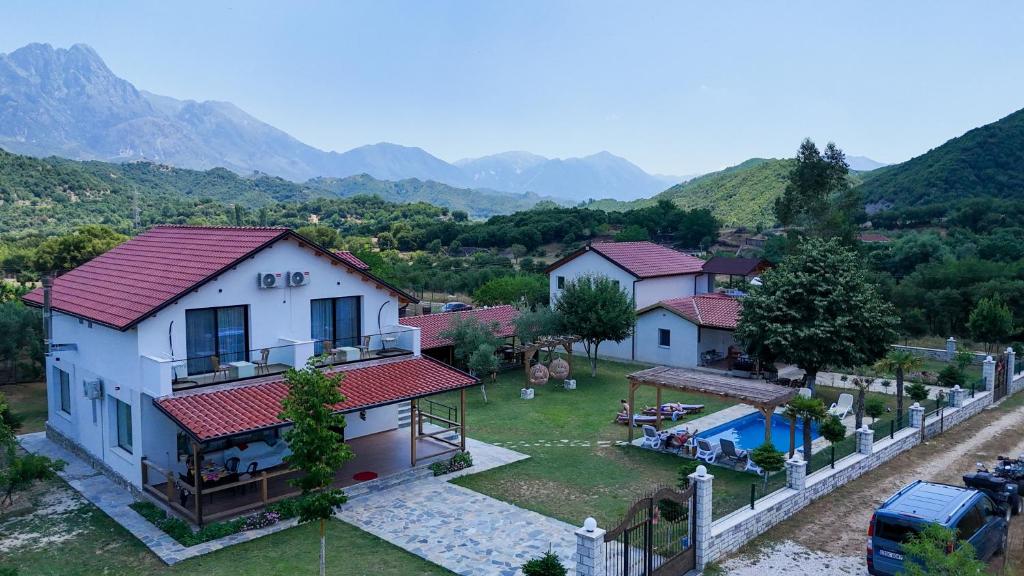 an aerial view of a house with mountains in the background at Guesthouse Micaj HORA in Himare