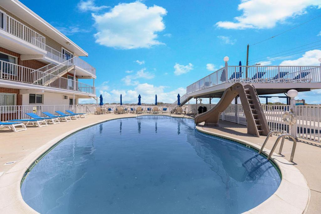 a swimming pool with a slide in a resort at Astronaut Motel in Wildwood Crest