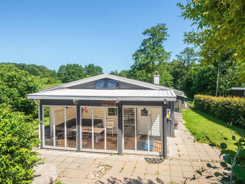 a greenhouse with a roof on a patio at 4 person holiday home in Haderslev in Haderslev