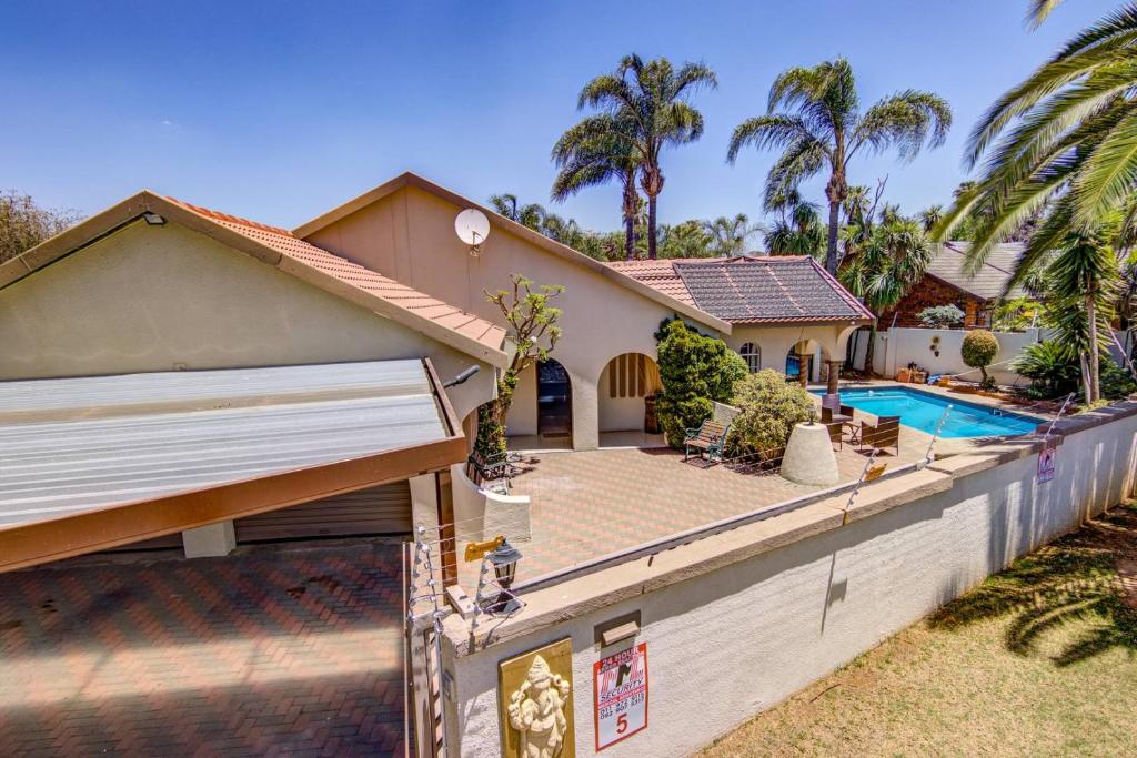 a house with a fence and a swimming pool at Kempton kingdom in Kempton Park