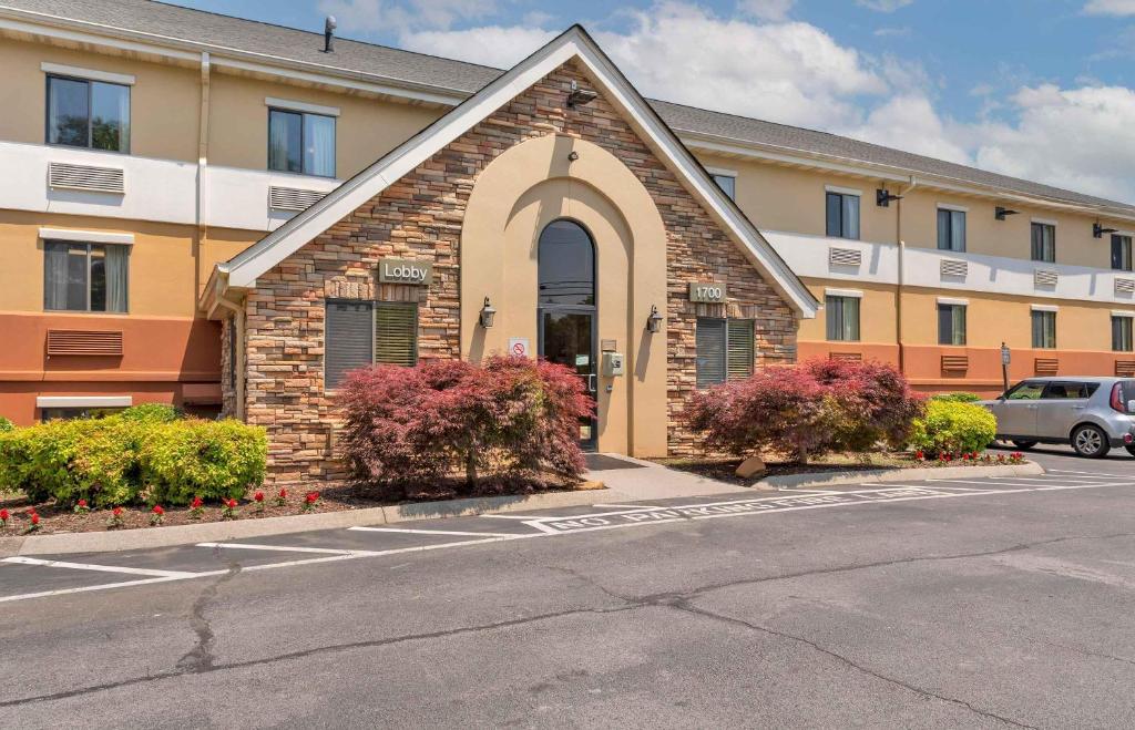 a building with a church with flowers in a parking lot at Extended Stay America Suites - Knoxville - West Hills in Knoxville