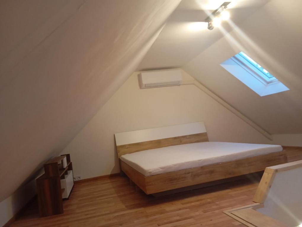 a small bedroom with a bed in the attic at Apartmán BB in Čížkrajice