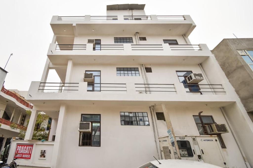 a white building with a balcony on it at Hotel O Pragati Inn in Jaipur