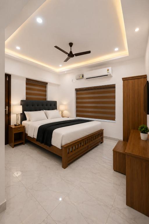 a bedroom with a large bed with a ceiling at Nibras Villas in Varkala