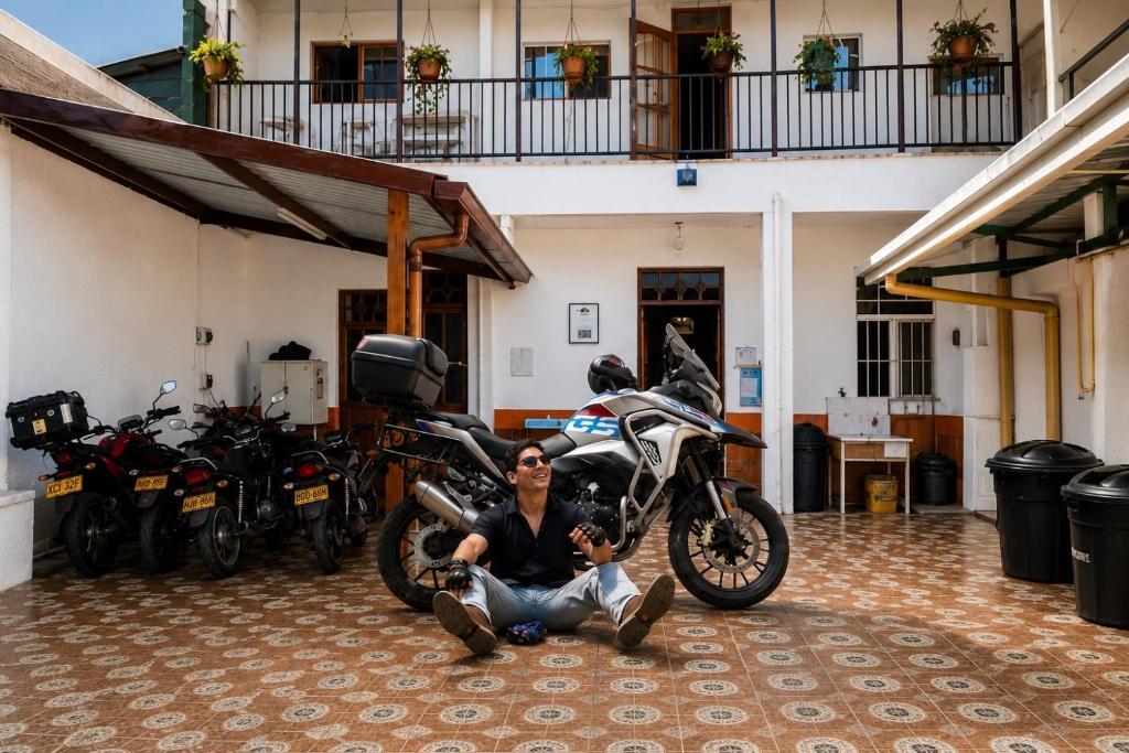 a man sitting on the floor next to a motorcycle at Casa Largo Katayama in Ruiosucio