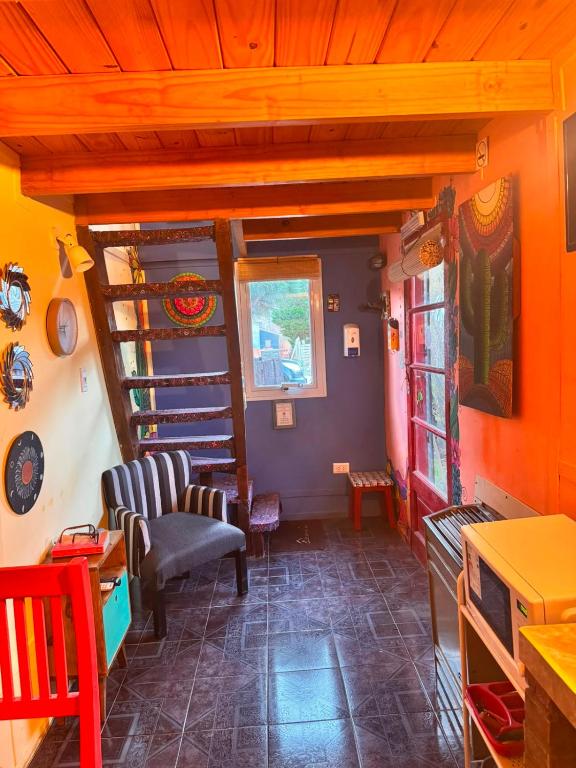 a living room with a spiral staircase in a house at El Kamaruco Tiny House in El Chalten