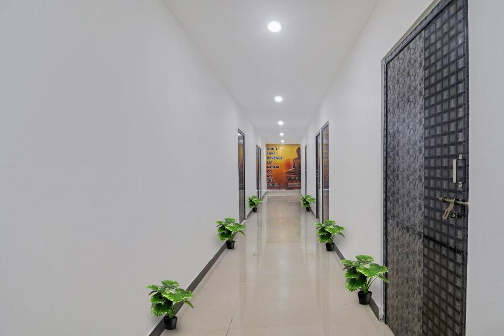 a hallway with potted plants in a building at OYO 93463 Alwal Residency in Hyderabad