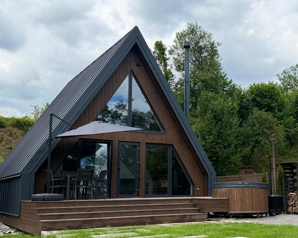 a house with a large window and a roof at Lofty House Mountain Tustan in Urych