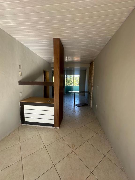 an attic room with a staircase and a room with a table at Apto a 50m da ExpoCrato in Crato