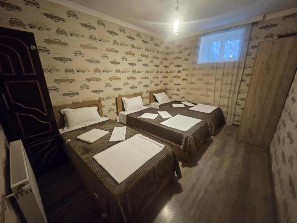 a room with two beds and a window at Niss House2 in Akhaltsikhe