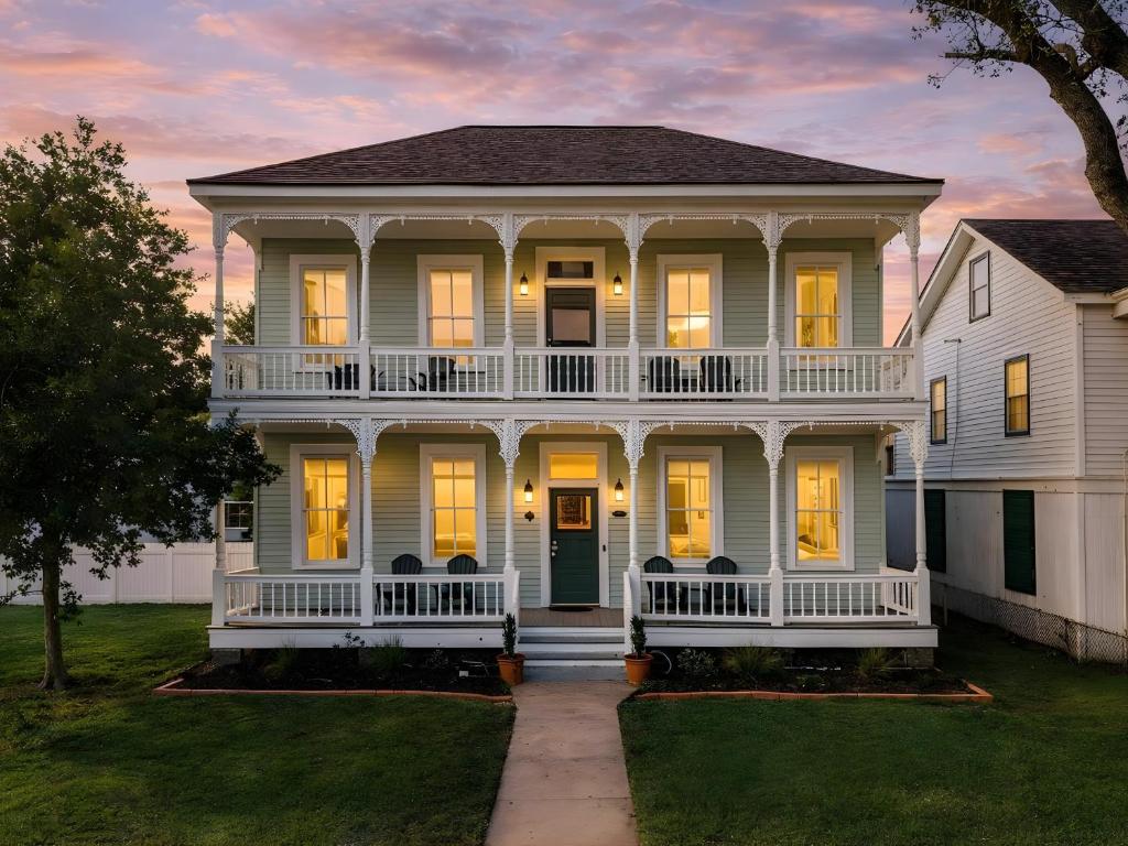a large white house with a front porch at Sand and Sea Manor in Galveston