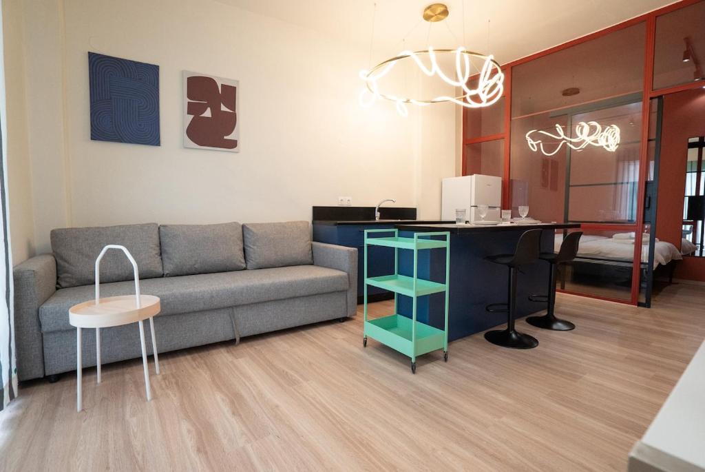 a living room with a couch and a desk at Volos Blue Nest in Volos