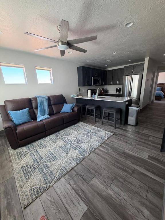 a living room with a couch and a kitchen at Desert view apartment in Page
