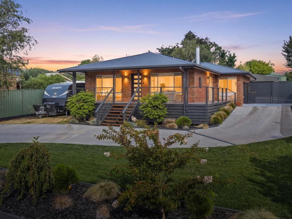 a home with a large house with a driveway at Links Golf Retreat in Mansfield