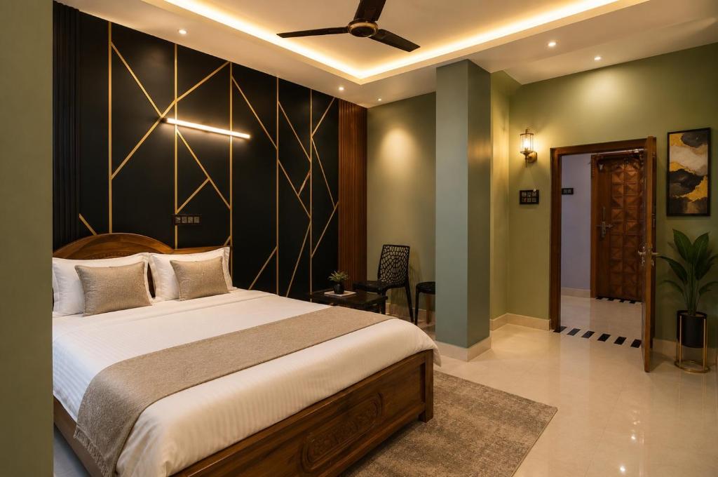 a bedroom with a large bed with a black wall at Winter Valley Grand Araku in Araku