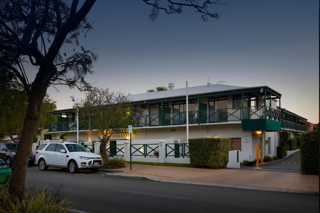 a white car parked in front of a white house at Windsor Lodge in Perth
