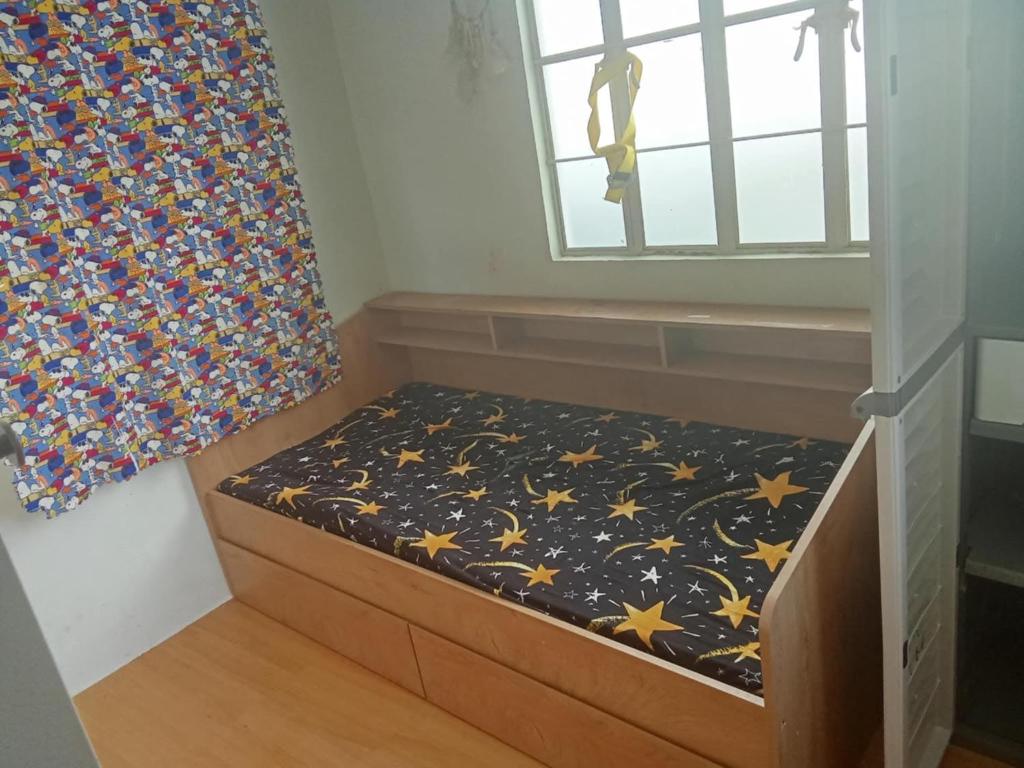 a small bed in a room with a window at Sanest Transient House in Subic