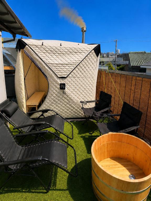 a group of chairs and a tent on a roof at Numazu Sparkle in Numazu