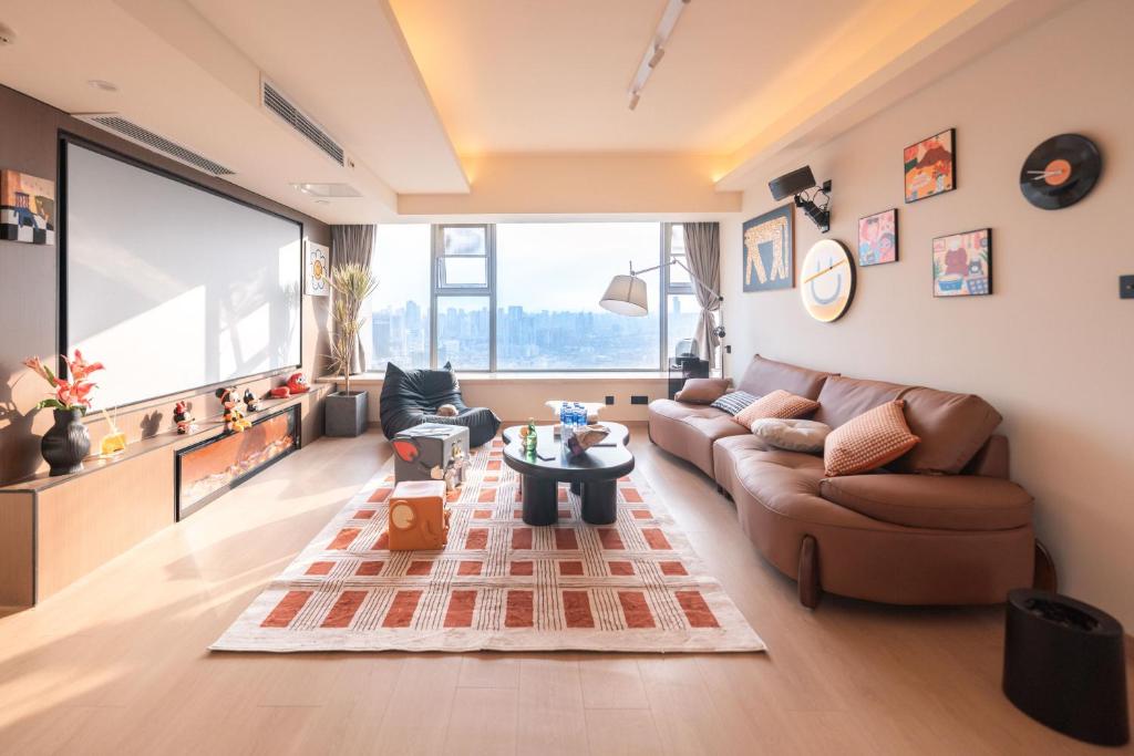 a living room with a couch and a table at INVIS Urban High-rise Suites in Chengdu