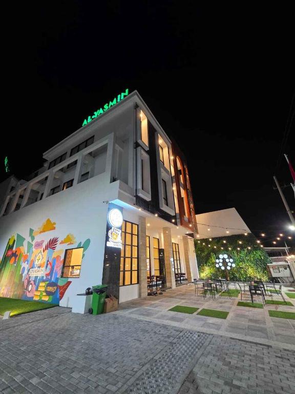 a building with a sign on it at night at AL-Yasmin in Surabaya