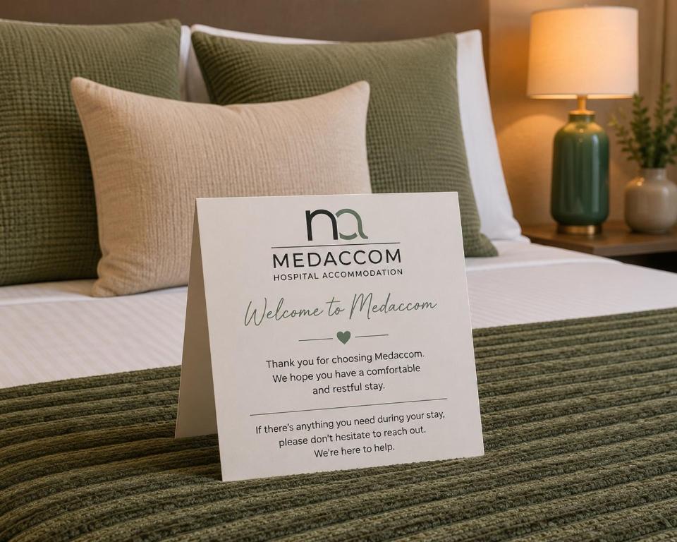 a sign sitting on a bed with at Med-Accom in Sydney