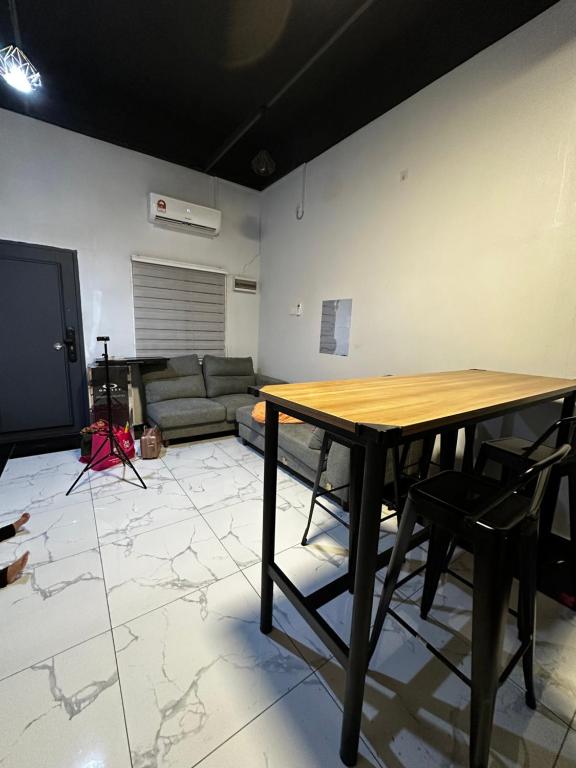 a living room with a wooden table and chairs at Inap Seri homestay in Jeram
