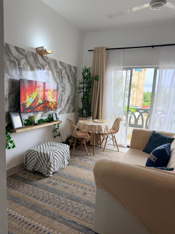 a living room with a couch and a table at SeaEsta studio Shanzu Serena in Mombasa