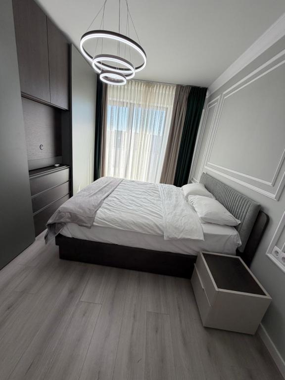 a bedroom with a bed and a large window at Best Luxury Residence in Bistriţa