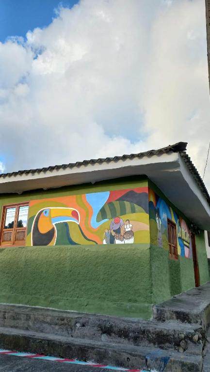 a building with a mural on the side of it at Casa turística la Nativa in Puracé
