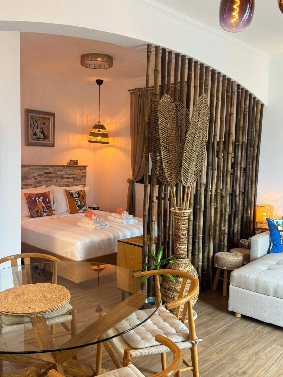 a hotel room with a bed and a table at Avra Guesthouse in Limenas