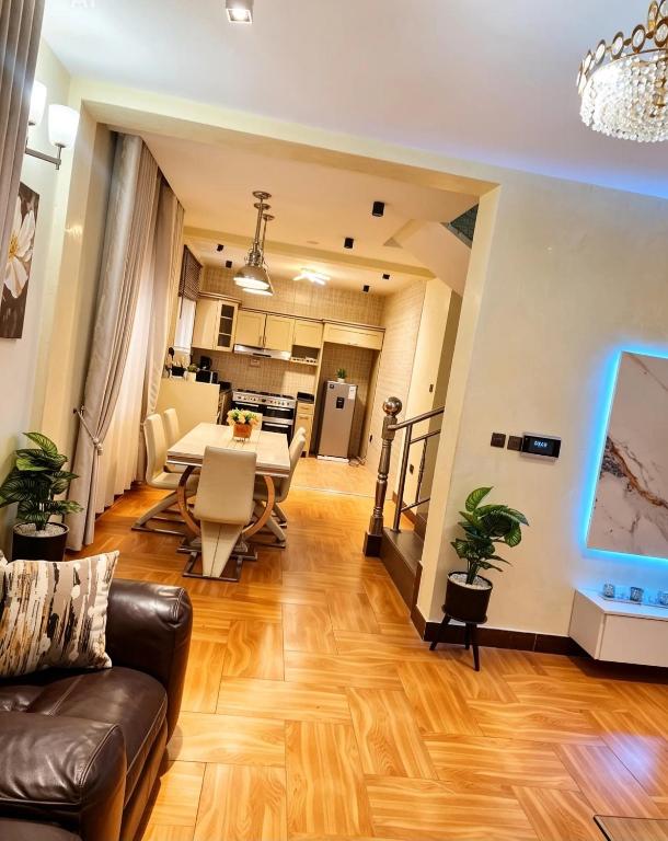 a living room with a couch and a table at Deluxe unique homes kampala in Kampala