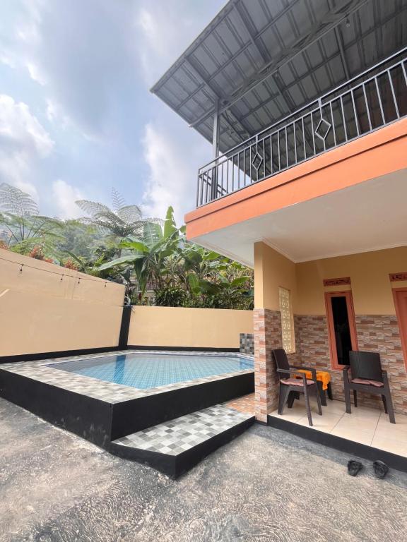 a pool in the backyard of a house at Villa Pondok Aurora in Campaka
